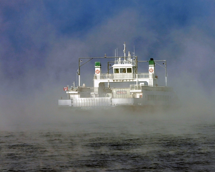 The Frontenac II ferry emerging through mist on the Amherst Island crossing