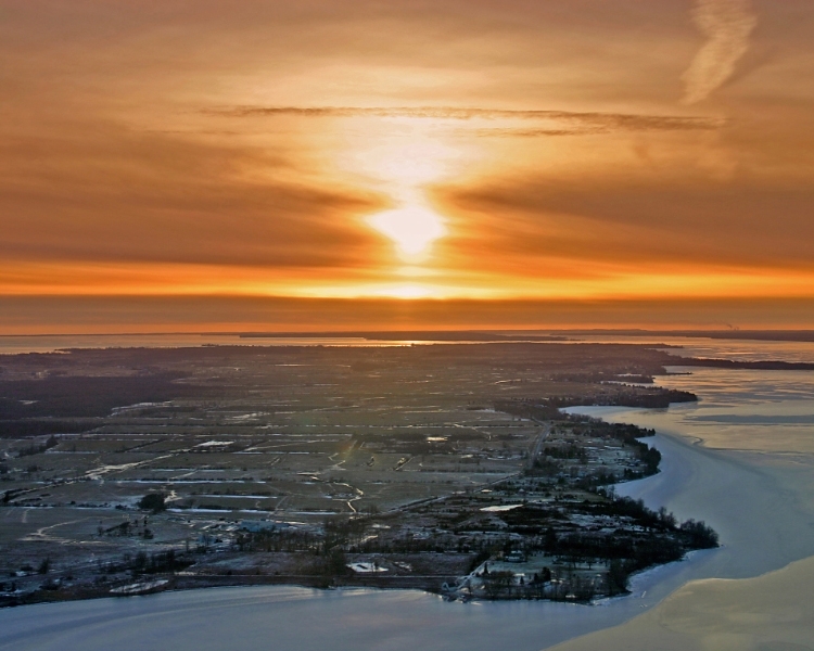 Aerial view of Amherst Island fields and shoreline at sunset